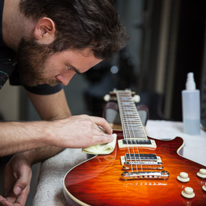 Luthier Polishing Electric Guitar